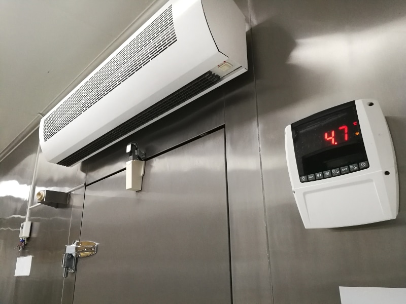 A cool room with a split system air conditioner and digital display, minimising cool room temperature fluctuations.