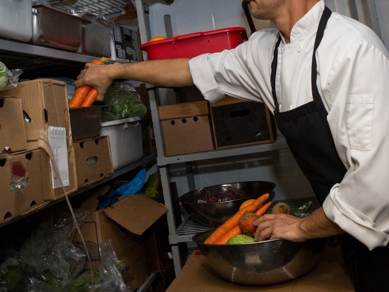 Chef organises vegetables after Walk in Refrigerator Repair.